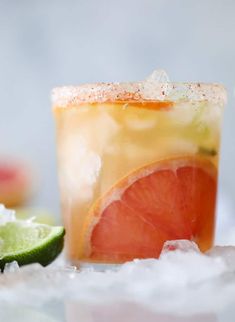 a close up of a drink with grapefruit and lime