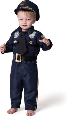 a little boy dressed up as a police officer with his hands in the air and wearing a tie