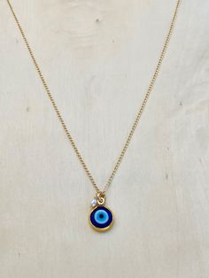 Cobalt Blue Evil Eye Necklace. Stay protected in style with this stunning blue glass evil eye charm. Eye charm measures approx. 10mm in diameter. Chain is gold filled. Clasp made in Italy. Stay protected! Buy yours today! Blue Birthstone Round Charm Necklace, Blue Gold-plated Charm Necklace With Adjustable Chain, Spiritual Blue Charm Necklace With Adjustable Chain, Yellow Gold Evil Eye Charm Necklace, Gold Plated Evil Eye Round Necklaces, Gold Plated Evil Eye Round Necklace, Gold Plated Round Evil Eye Necklace, Spiritual Blue Evil Eye Charm Necklace, Blue Evil Eye Necklace