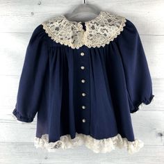 "Beautiful navy blue long sleeved dress. Lace trimmed hem and lace collar. Faux pearl buttons down the front. Great for Christmas, Birthday or any special occasion! Size: No size tag but looks around 12-18 months. Check measurements below to ensure fit. Measurements (approximate): Shoulder to Hem: 15\" Armpit to Armpit: 11.5\" Brand: Peaches 'n Cream Condition: Some yellowing on collar. See pictures for details. Be sure to check out my shop! New items added often! https://www.etsy.com/shop/Autum Long Sleeve Dresses With Lace Trim For Dress-up, Long Sleeve Dresses With Lace Trim For Dress-up Occasions, Fall Lace Trim Dress With Doll Collar, Fall Lace Dress With Lace Collar, Fitted Long Sleeve Dress With Scalloped Edges, Long Sleeve Lace Dress For Dress-up, Long Sleeve Dress With Lace Collar For Fall, Blue Lace Trim Dress For Fall, Blue Long Sleeve Vintage Party Dress