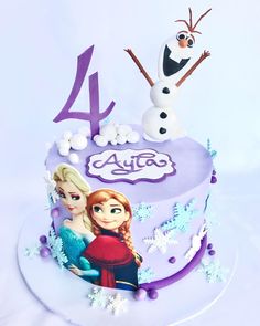 there is a birthday cake decorated with two frozen princesses on it and the number four