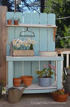 an outdoor potting bench with flowers on it