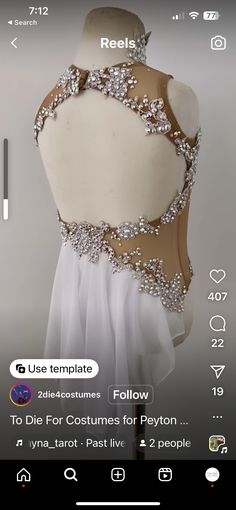 the back of a dress with beading and sequins is displayed on an iphone screen