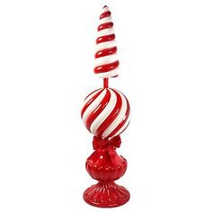 a red and white striped candy cane on a stand