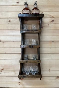 an old wooden shelf with glasses on it