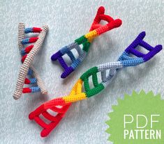 three crocheted toothbrushes are laying on a table with white and blue background