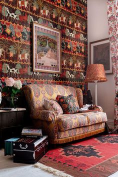 a living room filled with furniture and wallpaper covered in colorful patterns on the walls