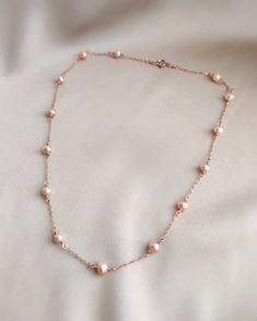 💗 Delicate Rose Gold Pearl Necklace with pink freshwater pearls & 14K Rose Gold Filled ✨ Dainty & Elegant. Simply beautiful necklace/ choker. A perfect gift & affordable treat for yourself.• Pearl size: 4-5 mm• Model picture is wearing 15" in length (model is 155 cm/ 5'1" height)• Handmade with genuine pink Freshwater Pearls. All metal parts are high-quality 14K Rose Gold Filled. It also can be made with 14K Gold-filled or Sterling Silver.• Gold-filled chain is known for its lasting quality. Th Delicate Pearl Necklace, Anniversary Rose Gold Pearl Drop Necklace, Rose Gold Pearl Necklace With Charm For Anniversary, Rose Gold Pearl Charm Necklace For Anniversary, Rose Gold Single Strand Pearl Necklace, Rose Gold Single Strand Necklace For Anniversary, Anniversary Rose Gold Pearl Necklace With Charm, Feminine Rose Gold Necklace With Pearl Drop, Feminine Rose Gold Pearl Drop Necklace