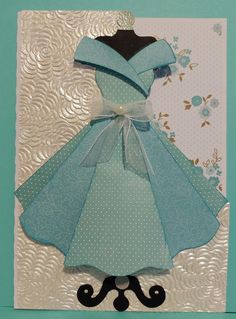 a card with a blue dress on it