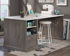 a sewing machine sitting on top of a wooden desk next to a white countertop