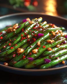 a plate with green beans and sauce on it