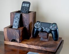 two video game controllers sitting on top of wooden blocks