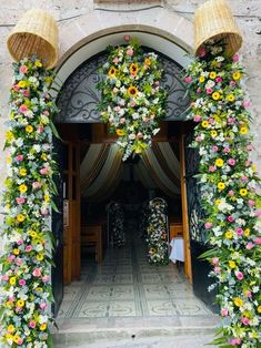 an entrance to a building decorated with flowers