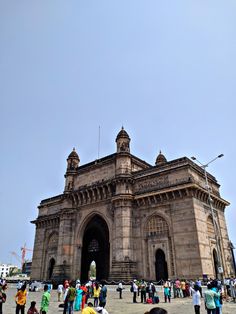 people are standing in front of an old building