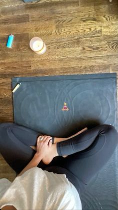 a woman laying on top of a yoga mat