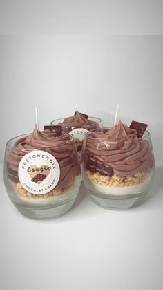 two desserts with chocolate frosting and marshmallows in small glass bowls