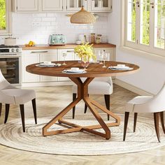 a kitchen table with white chairs around it