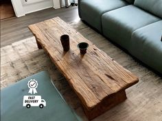 a wooden table sitting on top of a carpeted floor next to a blue couch