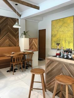 the interior of a restaurant with wooden stools