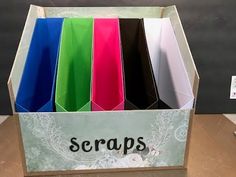 there is a box that has some paper in it and the word scraps written on it