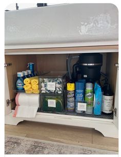 the under cabinet is filled with cleaning products and other things to use for washroom organization