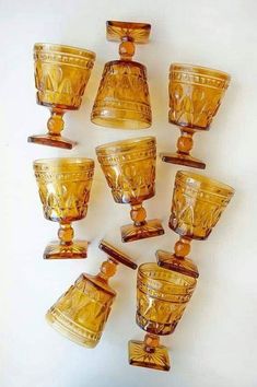 a group of yellow glass cups sitting next to each other