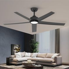 a living room with a sectional couch and ceiling fan