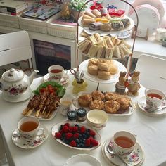 a table topped with plates and cups filled with different types of food on top of it