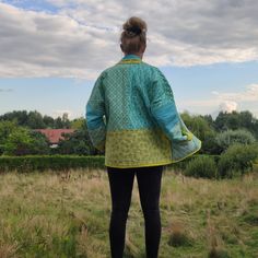 Beautiful handmade, colourful quilt short jacket with pockets, bohemian style and kimono cut, oversized. It's handmade 100% cotton quilt coat, reversible - one side is multicolor /in blue, yellow and green color/ patchwork fabric and second side is solid /lime color/ fabric. Inside cotton batting. Pockets on patchwork side. Size : S/M EU WOMAN'S  /for better wearing comfort, the coat must be little oversize/. Length : 28 1/2 inches (72 cm)  Bust/Chest : 47 1/2 inches (120 cm) Sleeve : customize All my works are myself handmade and unique. The coat is easy care and can be machine washed separately on a gentle cycle in cool water. FREE SHIPPING WORLDWIDE ! Oversized Bohemian Cotton Outerwear, Bohemian Oversized Cotton Outerwear, Oversized Cotton Quilted Jacket, Handmade Long Sleeve Cotton Outerwear, Traditional Oversized Outerwear For Spring, Handmade Bohemian Cotton Outerwear, Bohemian Quilted Spring Outerwear, Patchwork Kimono Sleeve Outerwear For Festival, Long Sleeve Cotton Kimono With Patchwork