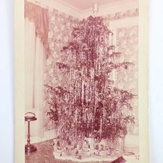 an old photo of a christmas tree in a room