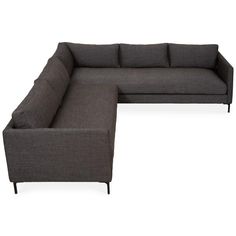 a gray sectional couch sitting on top of a white floor