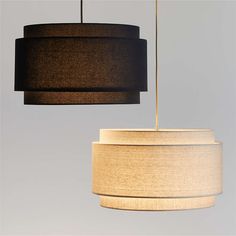 two lamps hanging from the ceiling with one light turned on and another being suspended off