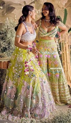 two women in colorful outfits standing next to each other