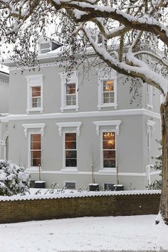 a house with snow on the roof and windows