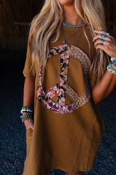 Effortlessly boho - chic, the Ebbie Peace Sign Tunic is the perfect dress for any occasion! You're going to find yourself always wanting to wear this dress! Comfortable Cotton tee shirt fabric Relaxed and loose tee shirt dress silhouette Classic round neckline and loose short sleeves So cute contrast floral peace sign center front patch Convenient side seam pockets Exposed seam with raw edges throughout for added boho style Pair: Eye Of The Sun Padded Bralette, Frenchie Raw Edge Shorts and Turqu Floral Peace Sign, Boho Essentials, Bralette Outfit, Dress Comfortable, Padded Bralette, Loose Tees, Tee Shirt Dress, Dress Silhouette, Shirt Fabric