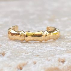 Polished 14KT yellow gold bamboo band design toe ring. Modern, yet earthy style toe ring perfect for your next vacation. Width: 3mm One size; adjustable Stamped 14K Weight: 1.07g Solid 14K Saint Jewelry, Earthy Style, Band Design, Toe Ring, Fabric Ribbon, Gold Polish, Toe Rings, Gifts For Teens, Spring Break