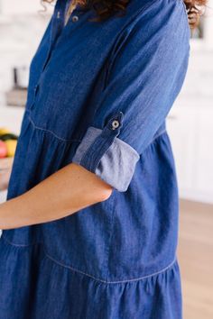 This 3 tiered denim dress is so versatile you will find yourself reaching for it to add a touch of trendy styling to any outfit. Wear as a dress or effortlessly open over your favorite tank and shorts. It features a babydoll bodice that creates a gorgeous shape, functional buttons, and a roll-tab sleeve for functionality throughout the months.Lightweight + Roll-Tab SleevesFunctional Front Close Buttons + Tiered Skirt100% CottonWash Cold, Hang Dry Fits True To Size *Measurements listed below are Plaid Headband, Blue Jean Dress, Buttery Soft Leggings, Darling Dress, Jeans Button, Denim Button Down, Button Down Dress, Find Yourself, Tiered Skirt