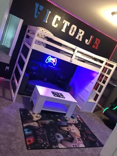 a room with a bunk bed, desk and video game controllers on the rugs