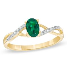 Richly colored with hints of subtle shimmer, this emerald and diamond-accented ring makes an elegant statement. Created in warm 10K gold, this ring showcases a 6.0 x 4.0mm oval-shaped lab-created bright green emerald center stone. The twisting polished and diamond-accented double shank completes this striking design. An exceptional look, perfect for the May birthday girl, this ring is finished with a bright polished shine. Elegant Emerald Promise Ring With Gemstone Accents, May Birthstone Ring With Diamond Accents For Formal Occasions, Formal May Birthstone Ring With Diamond Accents, Classic Emerald Ring With Gemstone Accents For May Birthstone, Emerald Birthstone Ring With Diamond Accents For Promise, Emerald Birthstone Ring With Diamond Accents, Elegant Green Birthstone Ring With Diamond Accents, Formal Green Birthstone Ring With Diamond Accents, Green Birthstone Ring With Diamond Accents