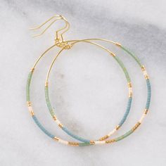 You asked for bigger beaded hoops and Libby & Smee answered! These dangly hoop earrings are the pieces you'll grab every day when you want a little something fun without a lot of fuss. Bonus: They look great dressed up or super casual. beaded hoops with tiny glass seed beads style: MUTED — slate blue and muted green with cream and gold choose from two large sizes: BIG, a teardrop shape approximately 1.75 inches wide and 2.75 inches long, or BIGGER, a circle shape 2.25 inches wide and 3 inche Trendy Nickel-free Beaded Hoop Earrings, Everyday Beaded Hoop Earrings, Nickel-free Heishi Bead Hoop Earrings, Adjustable Hoop Earrings With Dangling Beads, Nickel Free Hoop Beaded Earrings For Everyday, Trendy Hoop Earrings With Tiny Beads, Everyday Summer Beaded Hoop Earrings, Trendy Everyday Beaded Earrings, Adjustable Colorful Beaded Circle Hoop Earrings