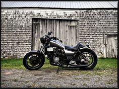 a motorcycle parked in front of a barn