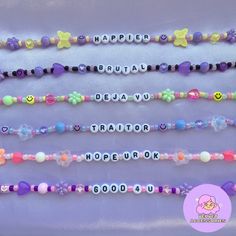 the name bead bracelets are arranged in different colors and shapes, with smiley faces on them