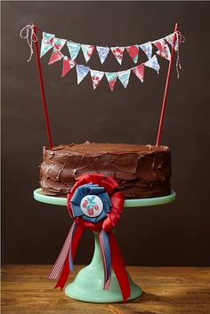 a chocolate cake with red, white and blue decorations on it sitting on a table