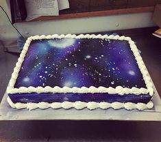 there is a large cake that has been decorated with stars and the sky on it