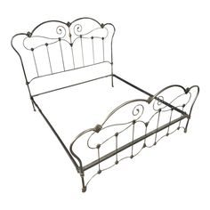 a metal bed frame with an iron headboard and foot board