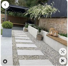 an outdoor garden with gravel and plants