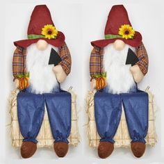 two gnomes sitting on top of each other with sunflowers in their hats