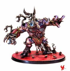 a painted warhammer is standing on a red base with horns and claws in his hands