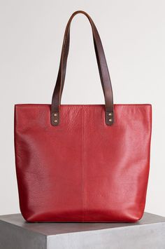 For travel, shopping, business meetings, or everyday carry, the Roma Leather Tote Bag is sized to serve. Premium Argentine cowhide leather with contrast leather handles give this tote its fashion appeal. The large interior has a full width slip compartment for a laptop, while the open interior includes two pen sleeves, three card slots, a small slip pocket, and a back wall RFID zip pocket, all secured by a magnetic snap closure. A wide exterior zip pocket keeps your immediate items close at hand Luxury Leather Tote Box Bag, Luxury Vegetable Tanned Leather Bags For Everyday Carry, Luxury Recycled Leather Tote Shoulder Bag, Bags Inspiration, Stylish Leather Bags, Rose Tote Bag, Crafted Bag, Best Tote Bags, Leather Portfolio