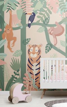 a baby's room with a tiger and monkey wallpaper